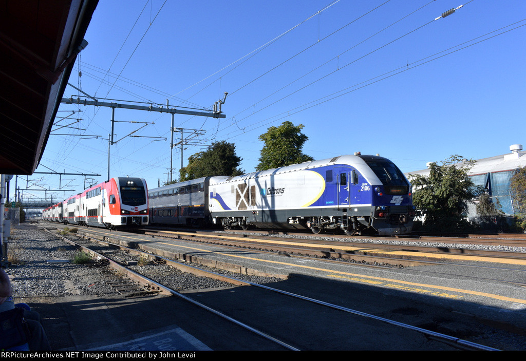 Charger # 2106 pushes Amtrak Train # 542 toward the next stop of Santa Clara University while Caltrain # 140 is about to make its station stop.